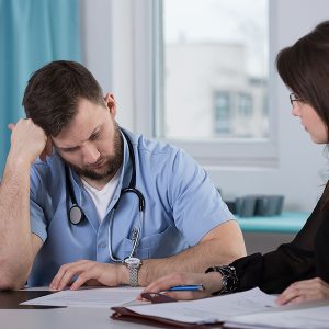 The Role of Mass Tort Cases in Defective Drug Litigation, Physician who commit medical error talking with lawyer